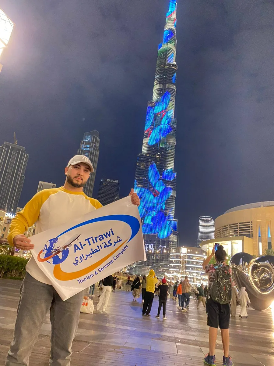 Client in Dubai holding Al Tirawi logo